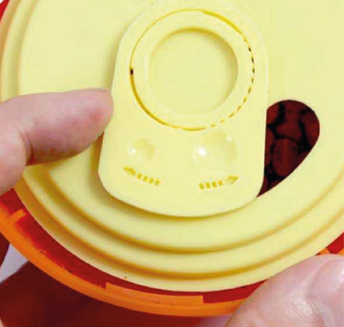 An open up treat ball showing the gauge opening for different size of treats