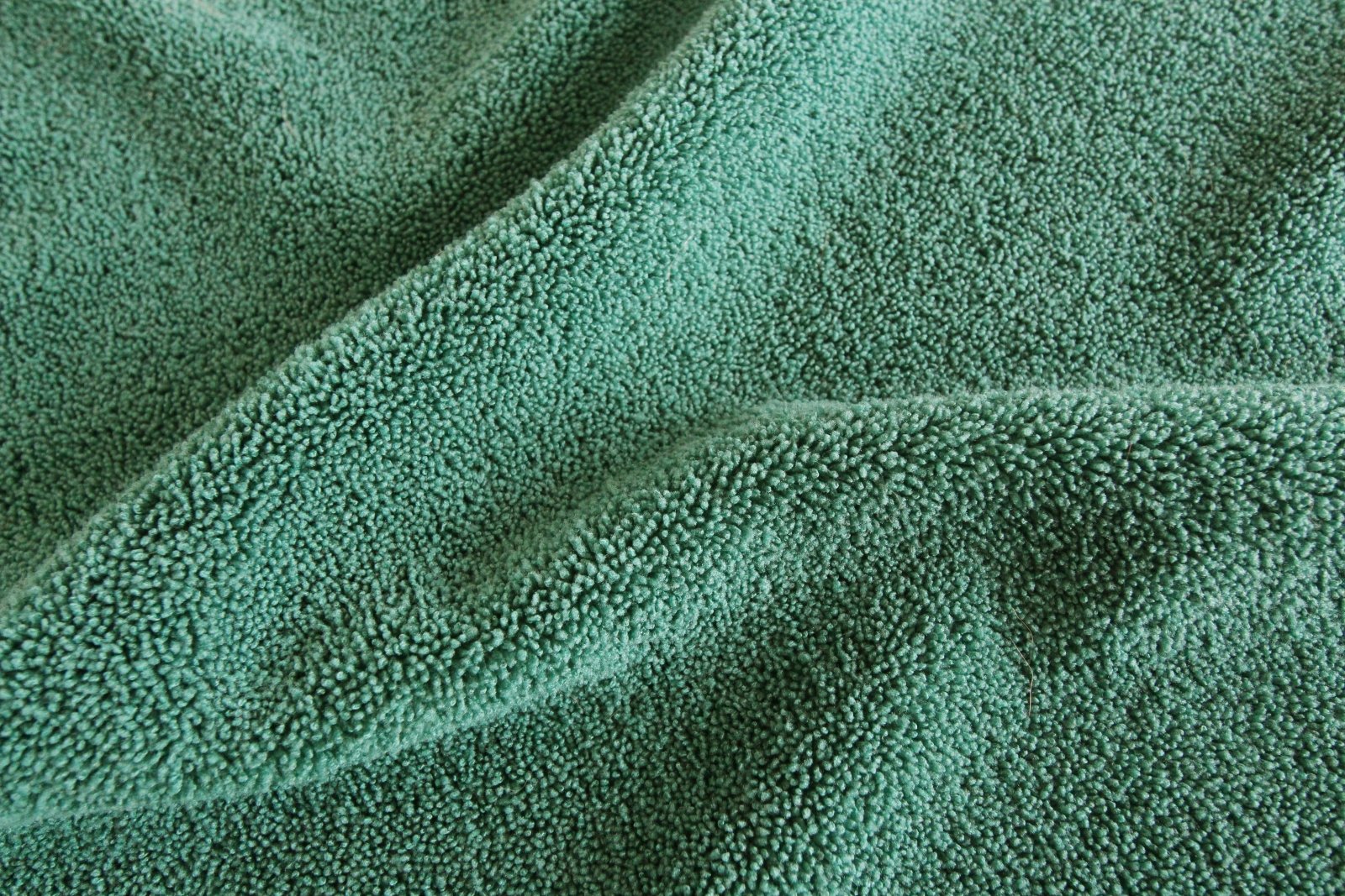 Green microfibre towelling close up showing the texture and softness